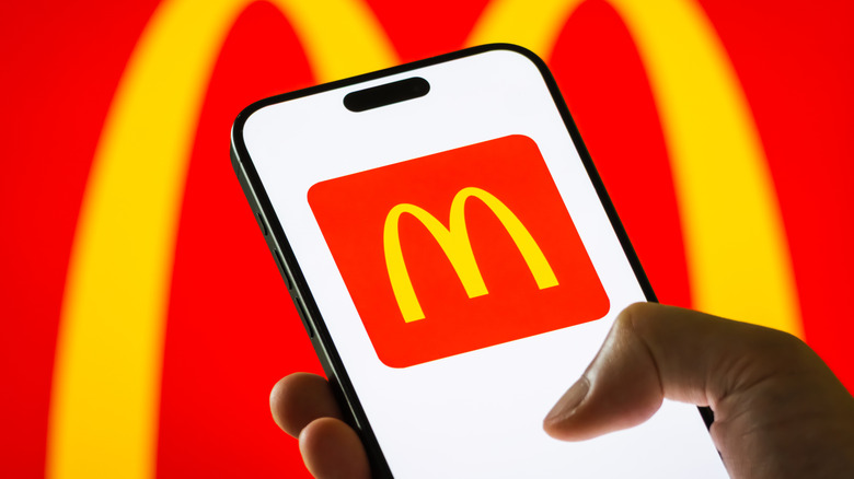 Hand using McDonald's phone app