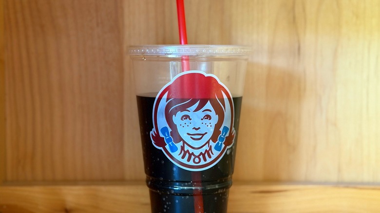 A plastic Wendy's cup against a wood background