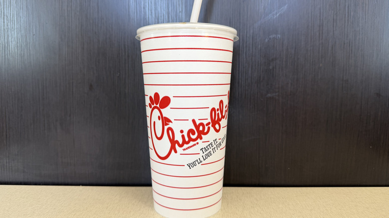 A paper Chick-fil-A cup against a dark grey background