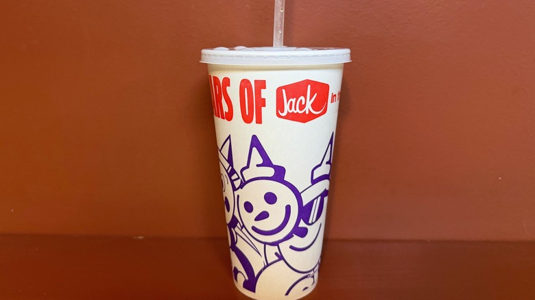A paper Jack in the Box cup against a red background