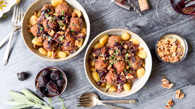 Fig and gorgonzola meatballs with radicchio in serving bowls with crispy gnocchi, garnishes, and dried figs