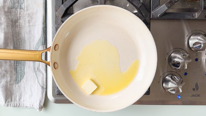 Heating butter and olive oil in large skillet on stovetop