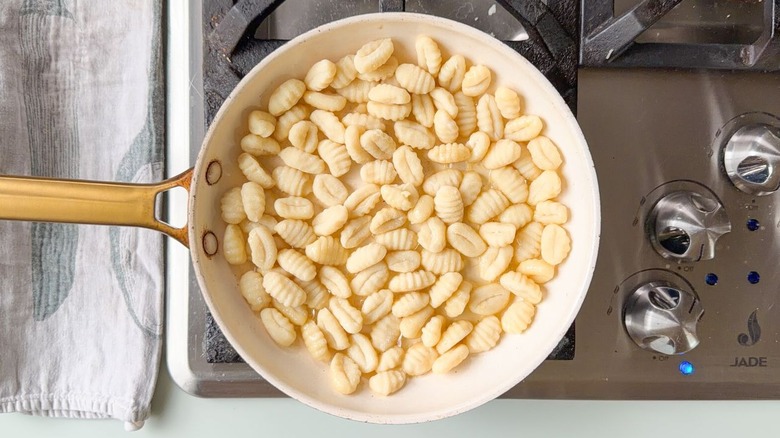 Potato gnocchi in large skillet on stovetop