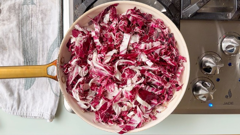 Sliced radicchio in large white skillet on stovetop