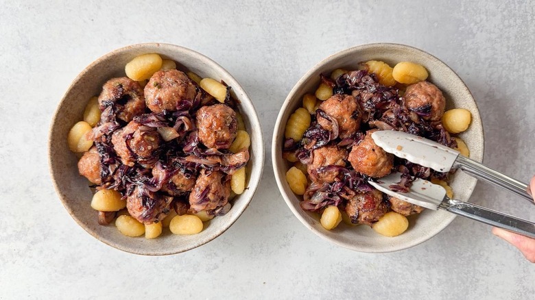 Serving fig and gorgonzola meatballs with radicchio over crispy gnocchi in serving bowls