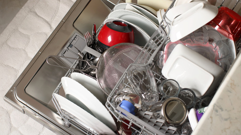 Open dishwasher packed full