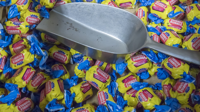 A pile of individual pieces of Dubble Bubble bubblegum, with a metal scoop