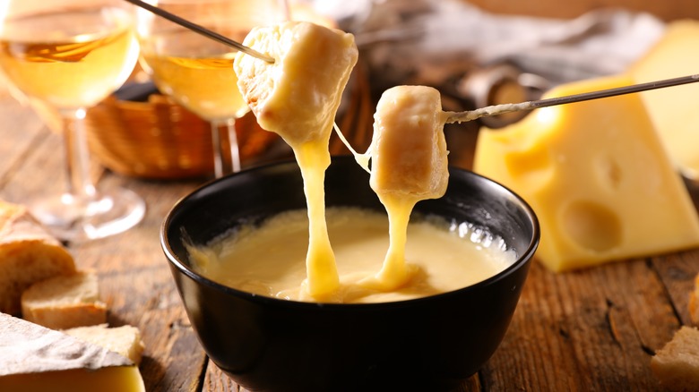 dipping bread into fondue