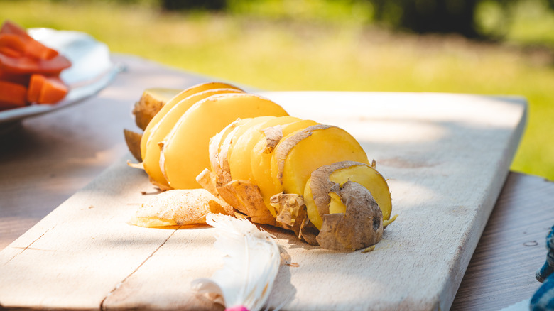 Sliced potato on wooden board outdoors