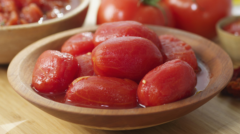 canned tomatoes in wooden bowl