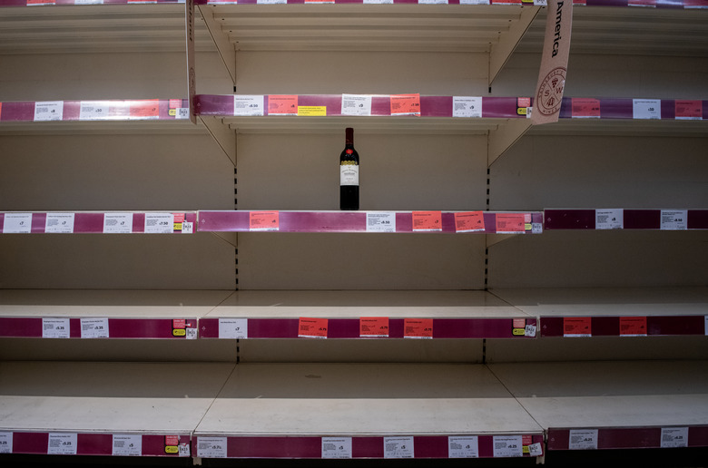 Lone wine bottle on grocery store shelf during coronavirus pandemic