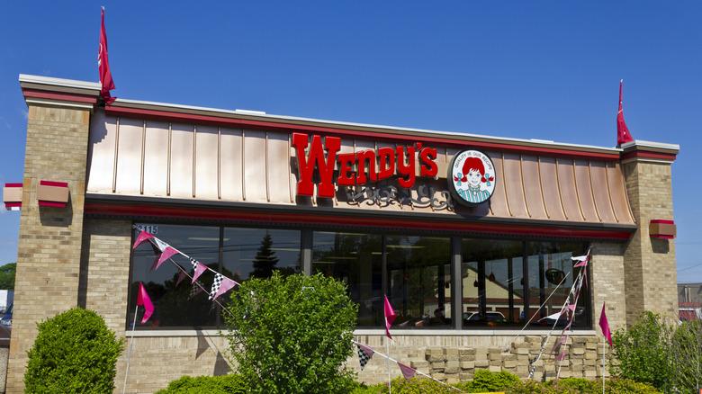 A Wendy's restaurant against a blue sky