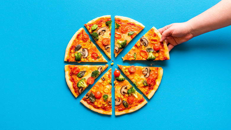Veggie pizza with hand