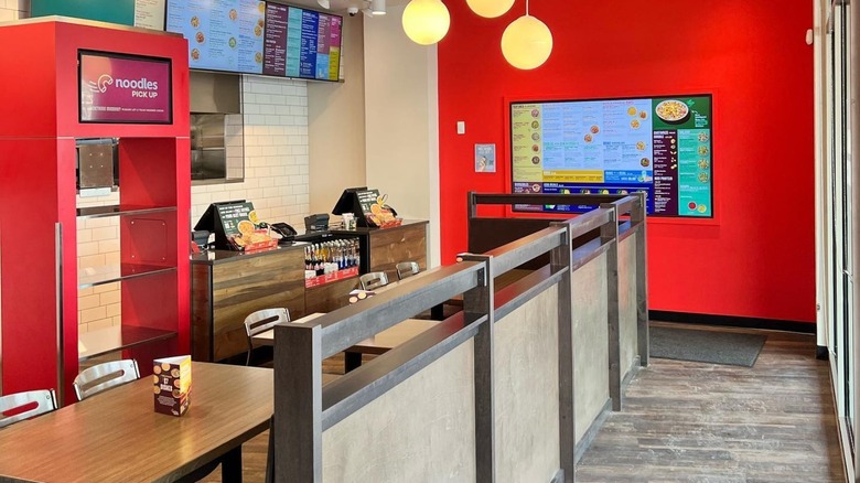 Noodles & Company restaurant interior with tables and cash register