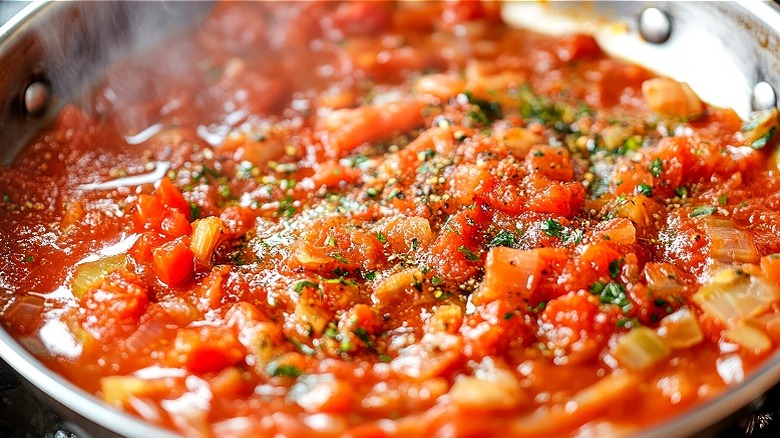 tomato sauce cooking in a stainless steel skillet