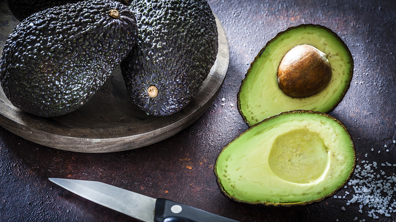 three avocados and knife