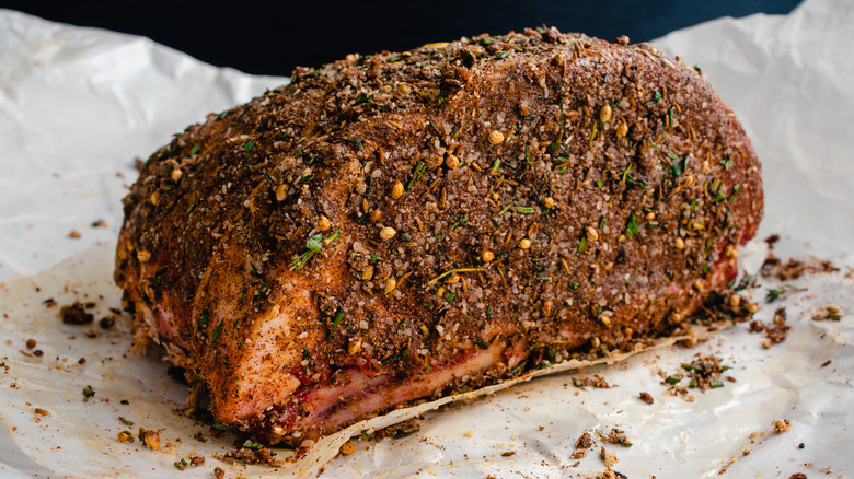 Raw rib roast covered in a spice rub