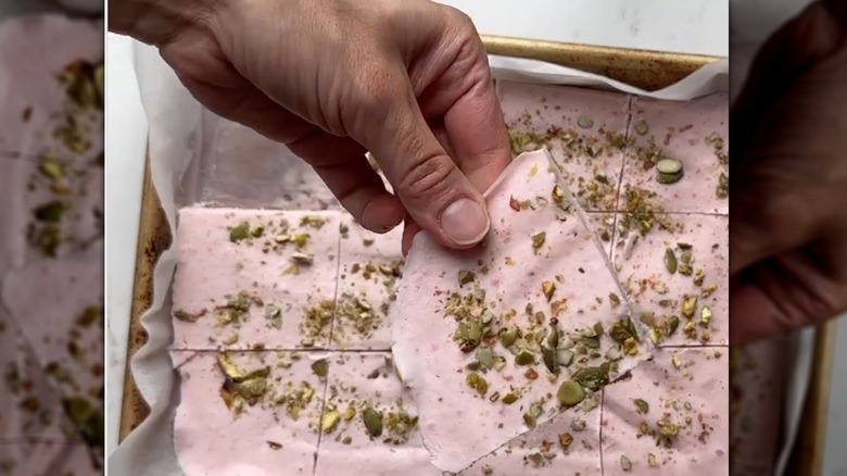 hand holding piece of cottage cheese bark