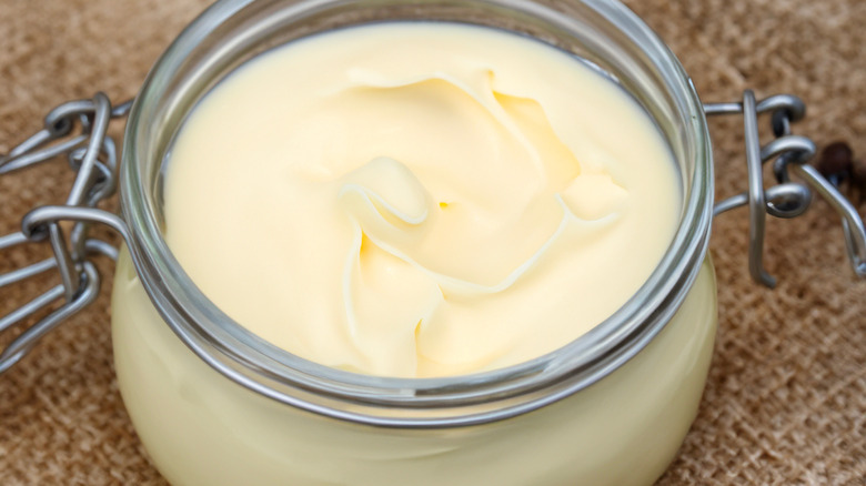 A close-up of a glass jar full of solidified beef tallow