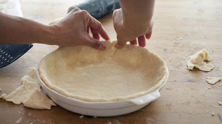 Pressing pie dough into dish