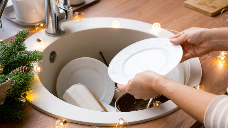 Cleaning dishes in sink during holidays