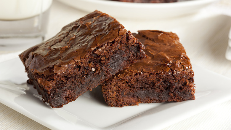 Chocolate fudge brownies fresh out of the oven on white plate