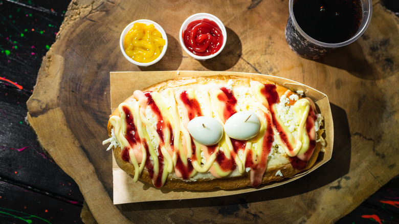 Colombian-style hot dog with ketchup and mustard in little containers
