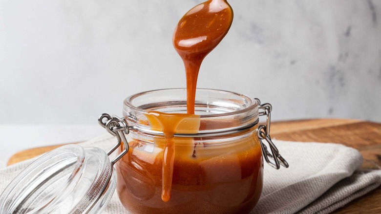 Caramel sauce dripping off a spoon