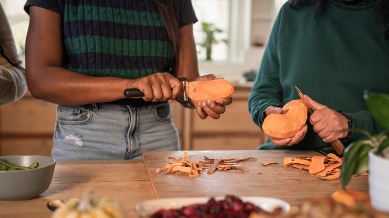 People peeling sweet potatoes