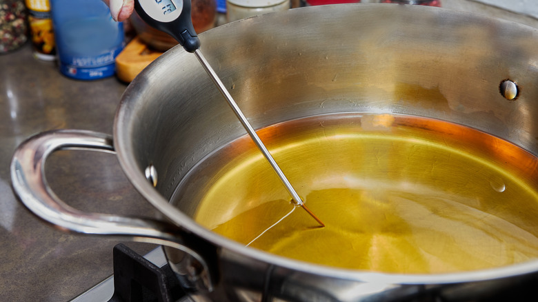 Hot oil in a pot with thermometer