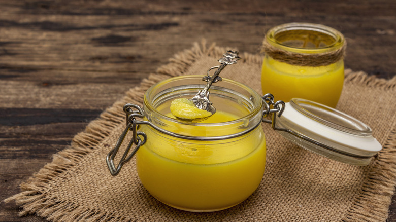 Clarified butter in glass jar with spoon
