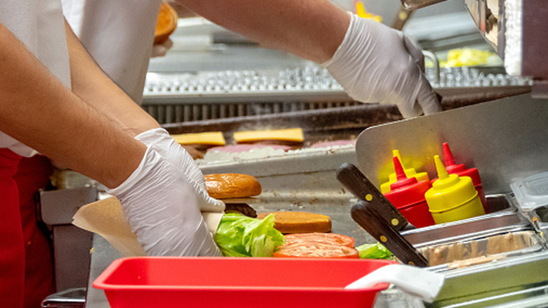 Fast food workers assembling orders in a kitchen