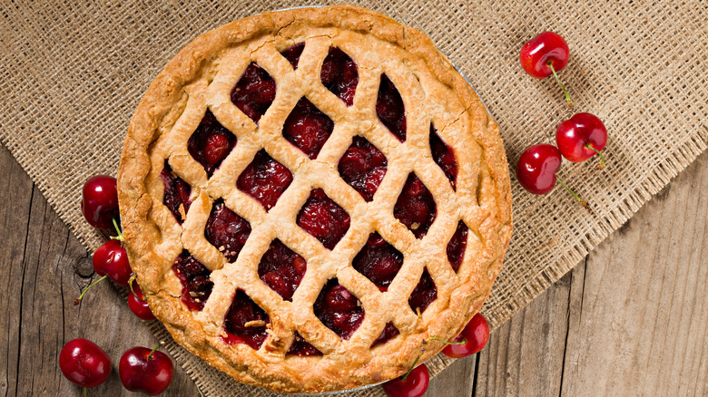 Cherry pie next to cherries