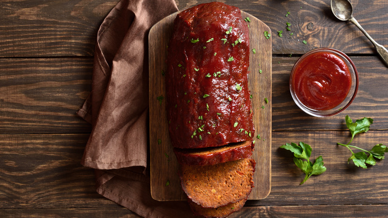 Meatloaf with glaze on cutting board