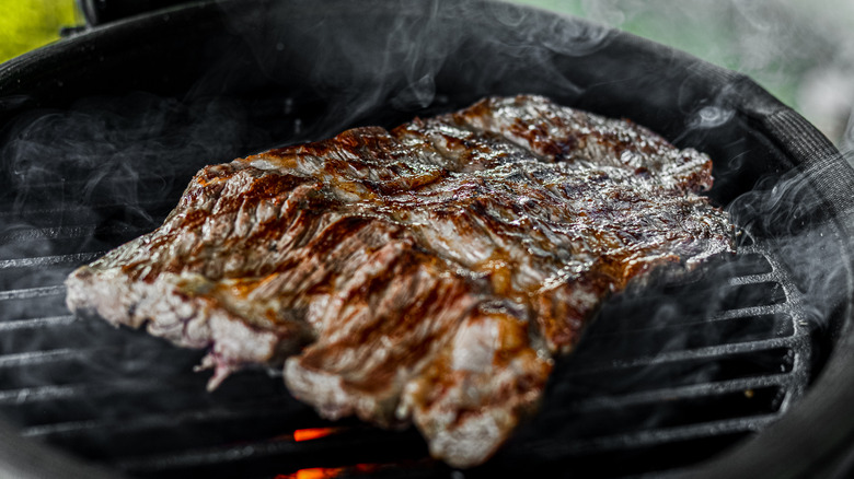 Skirt steak searing on a grill