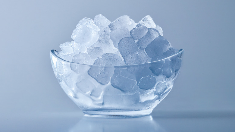 A bowl of ice against a blue background