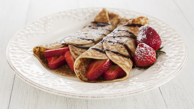 strawberry crepes with chocolate drizzle