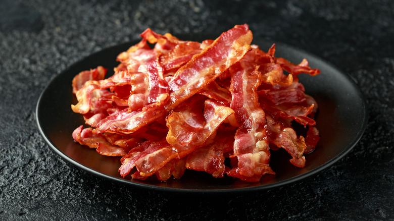crispy bacon stack on black plate