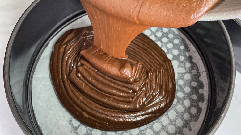 filling a pan with cake batter