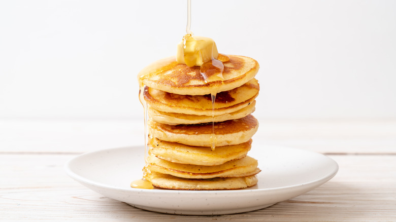 Stack of pancakes with butter and syrup
