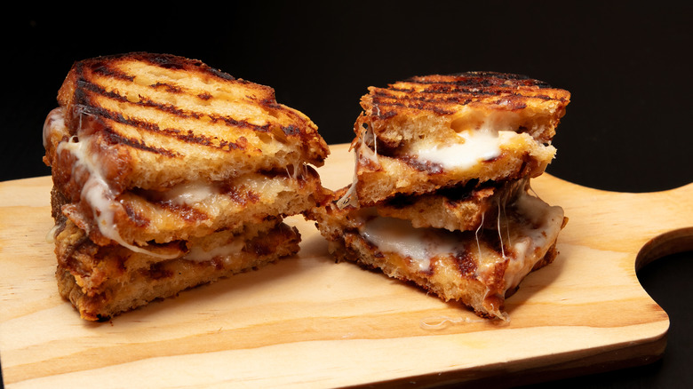 Sliced grilled cheese on cutting board