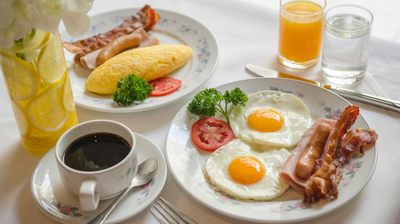 Breakfast with fried eggs, bacon, and sausage