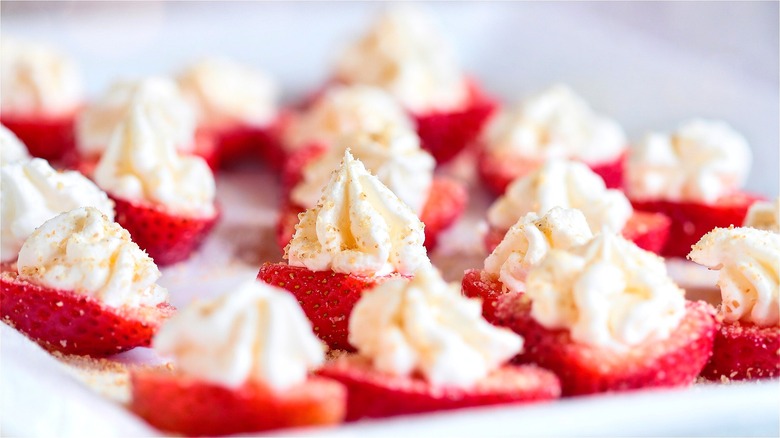 Halved strawberries filled with whipped cream