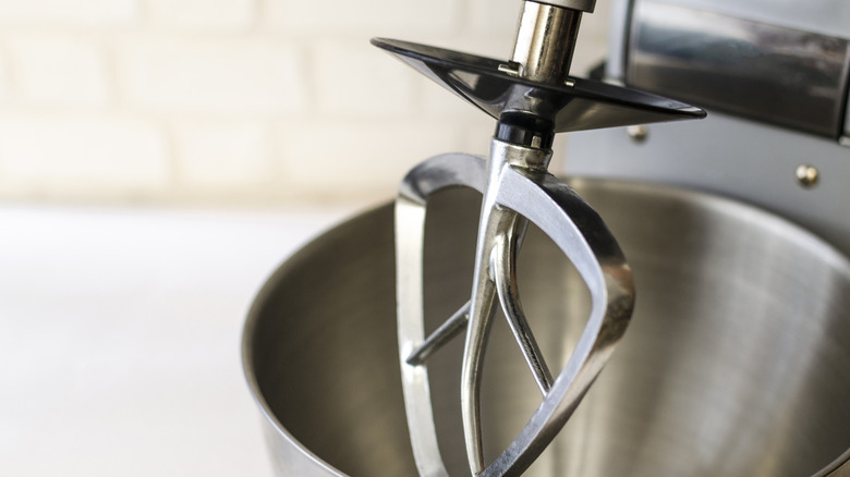 A stand mixer on a counter with paddle attachment