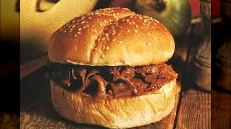 Arby-Q beef and sauce burger on wooden table