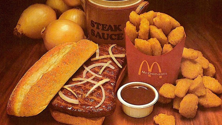 McDonald's beef sandwich and onion nuggets on wooden table