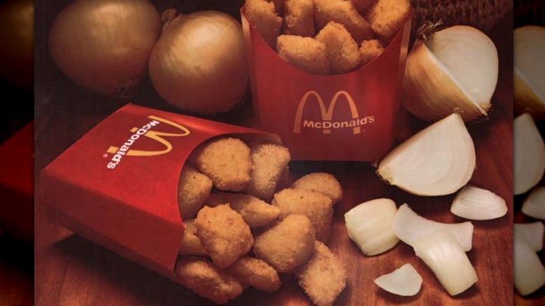 McDonald's Onion Nuggets in red container by raw onions