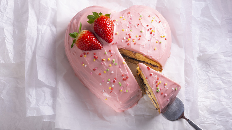 A pink heart shaped cake