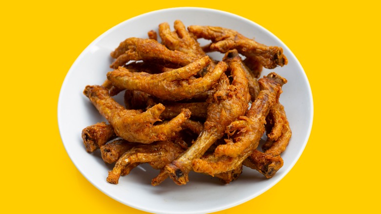 plate of fried chicken feet with yellow background