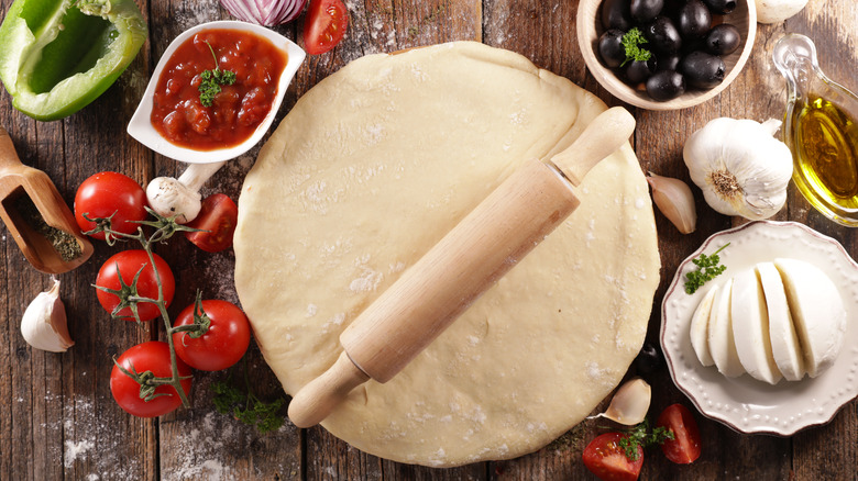 Pizza dough with rolling pin